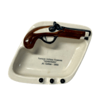 a porcelain dish with a gun on it